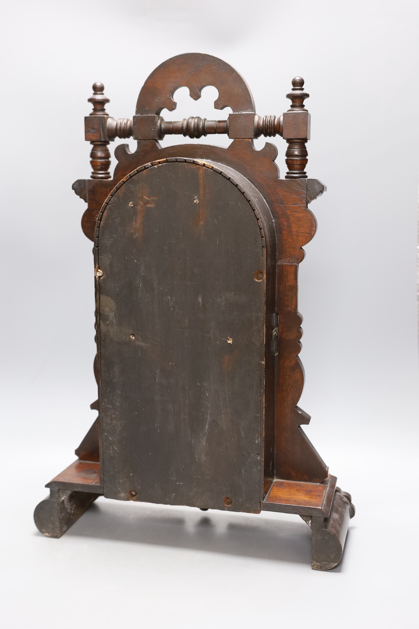 An architectural carved walnut mantel clock - 52cm tall